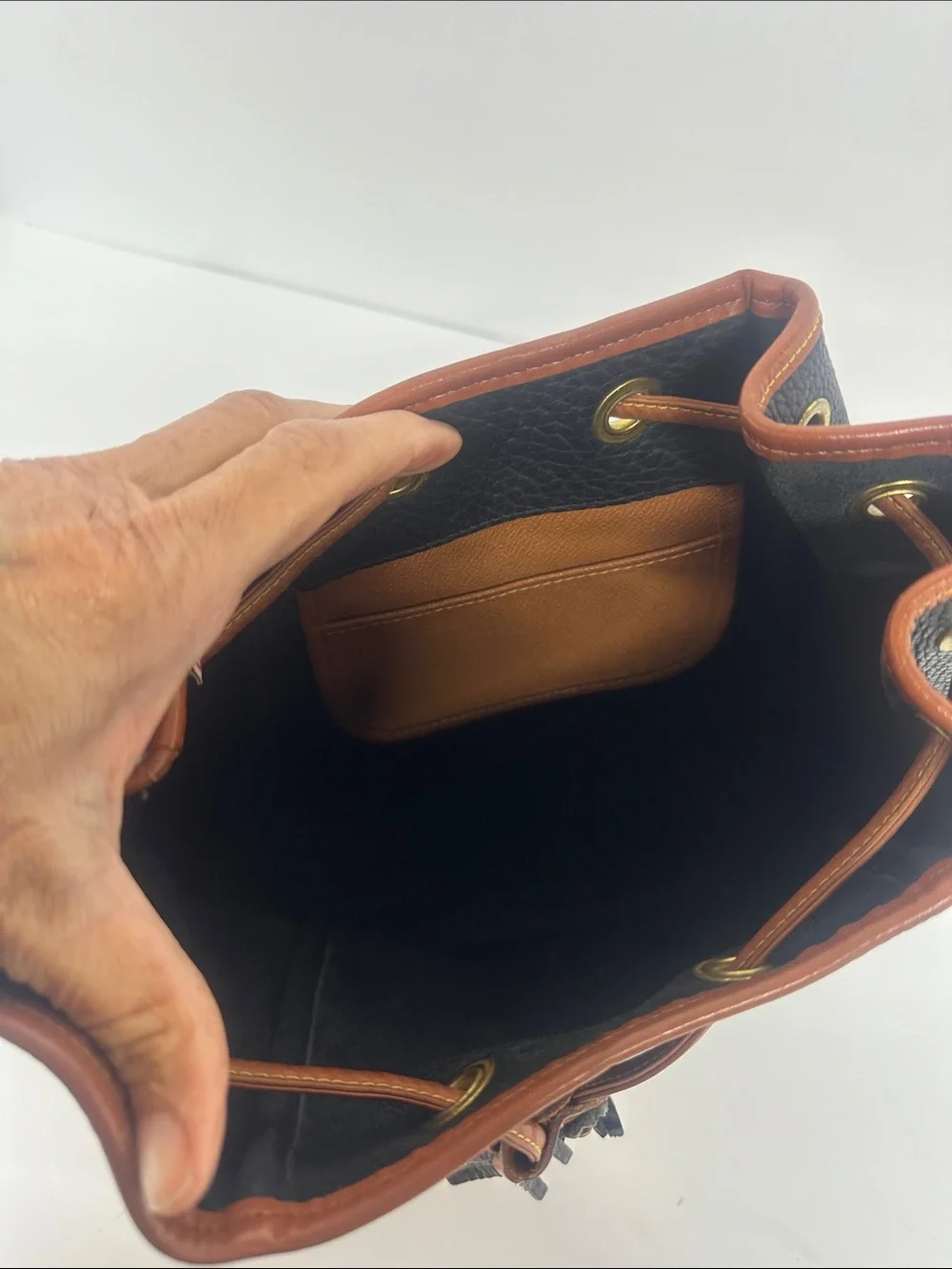 Dooney & Bourke Black Pebbled Leather Drawstring Bucket Bag with Tan Trim